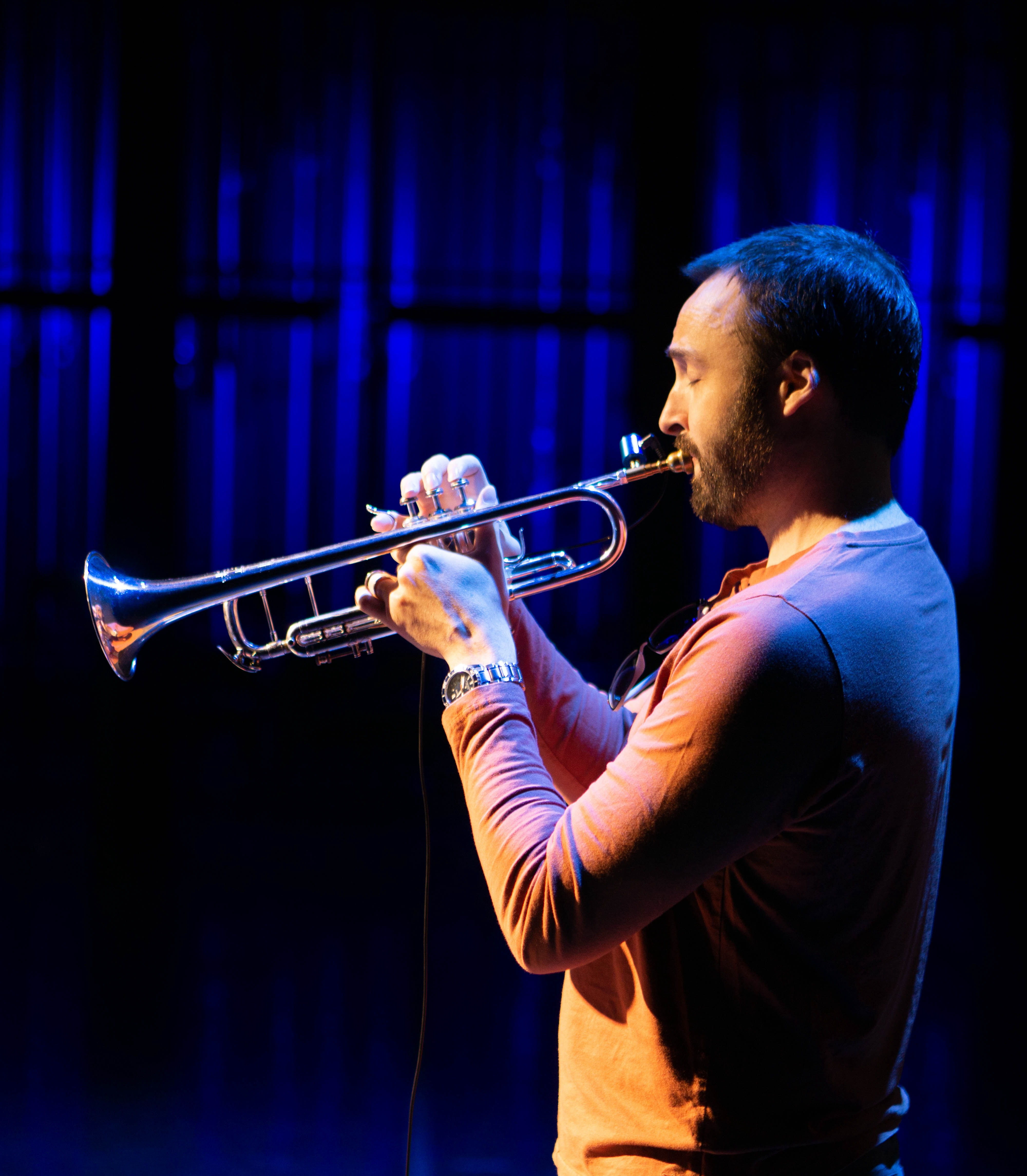 Cameron Summers performing trumpet live on stage