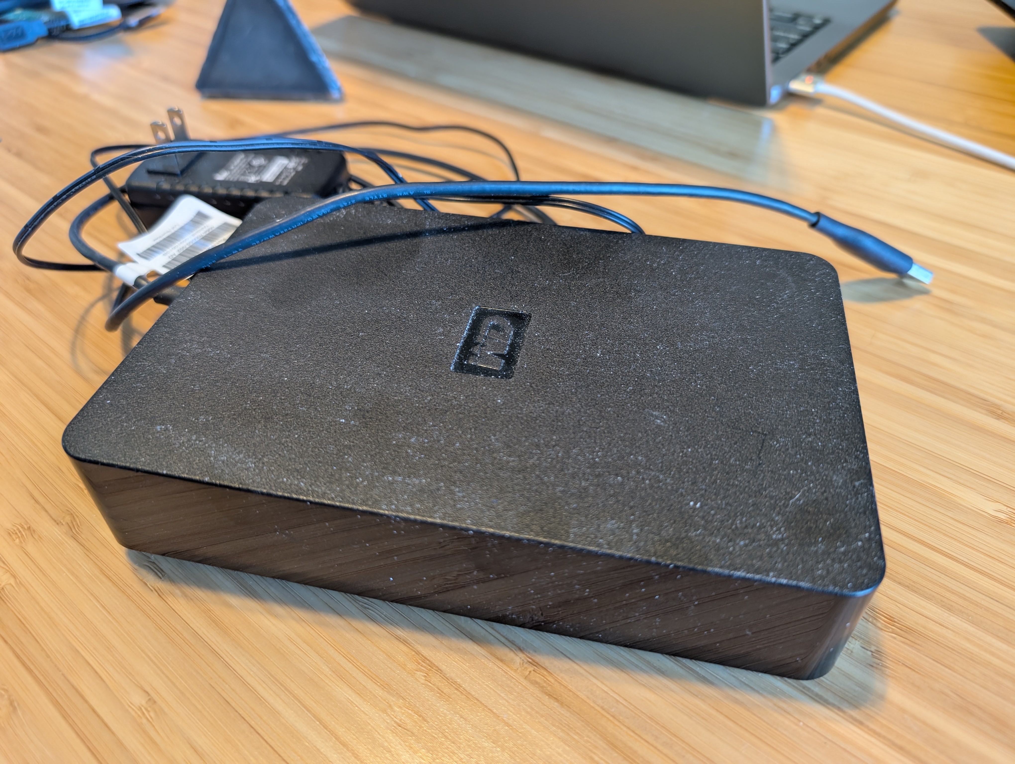 An old external hard drive, visibly dusty from years of storage.