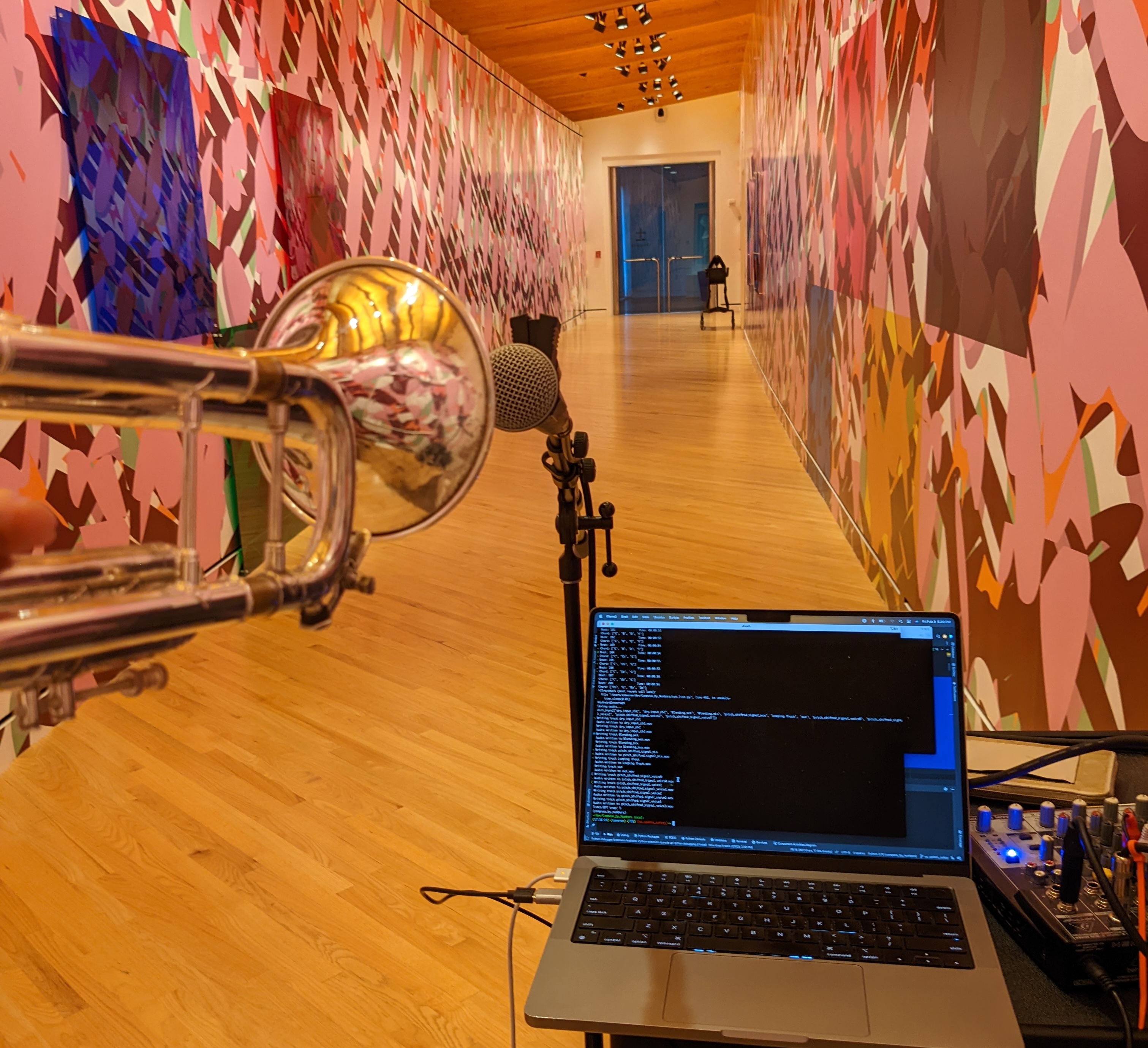 TechTet performance setup with trumpet, microphone, and live coding rig.